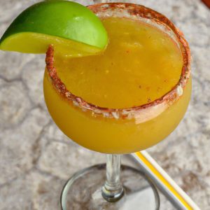 A glass of Quick Indian Spiced Mango Margarita with a lime wedge garnish