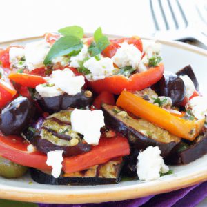 A colorful grilled eggplant salad with feta cheese, olives, and tomatoes.
