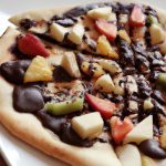 Closeup photo of a Grilled Fruity Chocolate Pizza on a white plate.