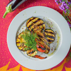 grilled eggplant with a variety of garden vegetables and herbs sprinkled over it, set on a white plate with a colorful background