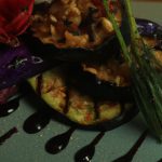 Close up of a plate of grilled eggplant with a secret garden twist.