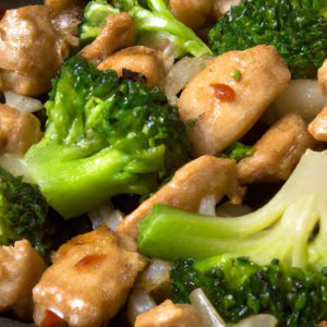 A close-up of a cast iron skillet filled with Chinese chicken and broccoli stir fry.